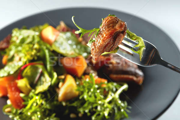 baked pumpkin, steak and arugula on a fork Stock photo © artjazz