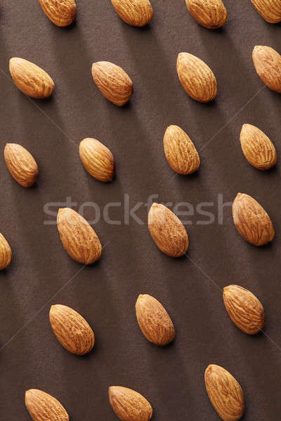 Nuts of almonds on a brown paper background. Vegetarian food Stock photo © artjazz