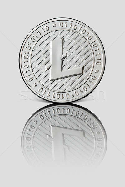 Silver coin Litecoin on white glossy background. Business and technology concept Stock photo © artjazz