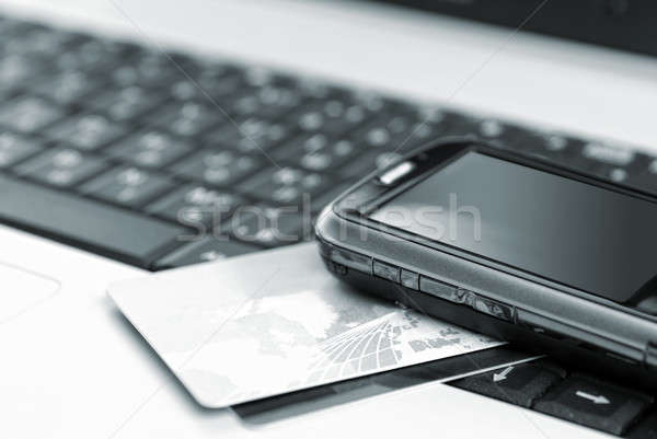 Credit cards and mobile phone on the notebook Stock photo © artjazz