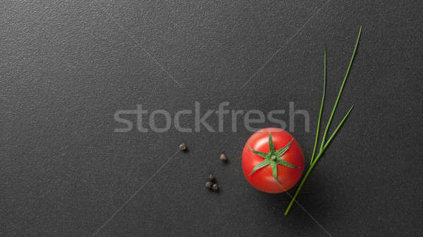 Stock photo: red tomato with green onion on black