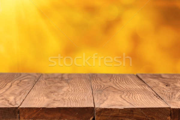 wooden table and backround with autumn leaves Stock photo © artjazz