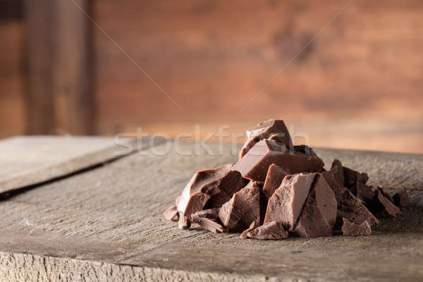 Stock photo: Pieces of milk Chocolate on wood