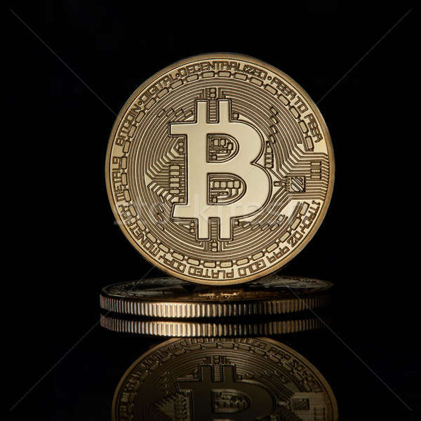 Stacked golden bitcoins coins for BTC cryptocurrency on a black reflective surface background Stock photo © artjazz