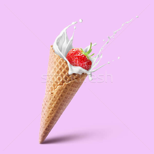 Ice cream waffle cone with milk splash and strawberry isolated on pink Stock photo © artjazz