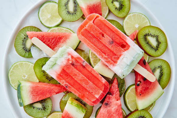 Frozen watermelon smoothies on a stick in a bowl with pieces of  Stock photo © artjazz