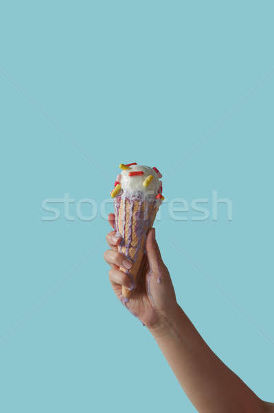 A female hand holds ice cream with pills on a blue background. C Stock photo © artjazz