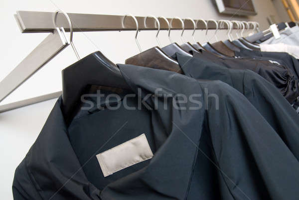 Stock photo: clothes on racks in store