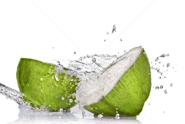 Green coconut with water splash isolated on white Stock photo © artjazz