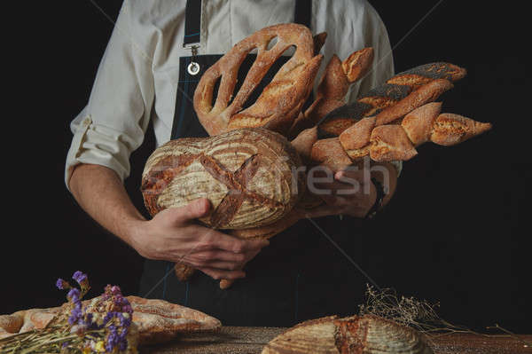 Variety of bread hold men's hands Stock photo © artjazz