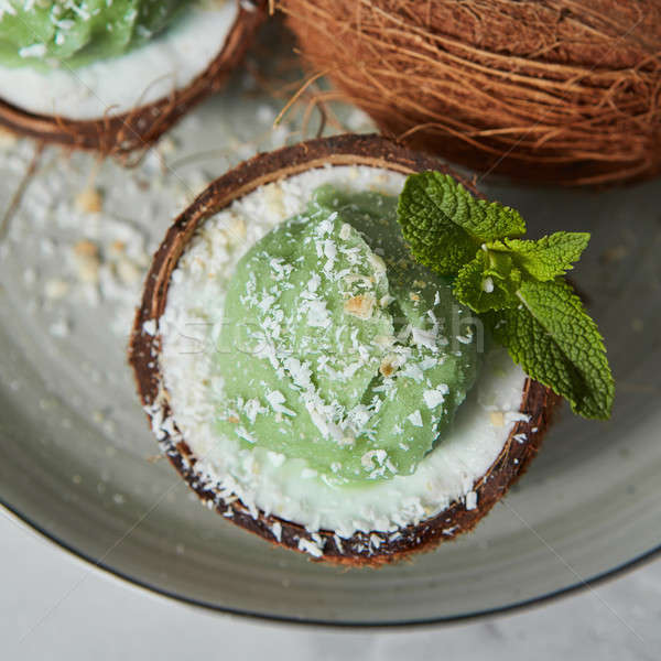 Close-up view a half of coconut with green mint ice cream with s Stock photo © artjazz