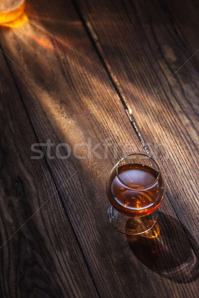 Cognac in glass on the wood Stock photo © artjazz