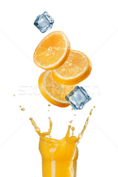 slices of orange falling into juice splash in glass isolated on  Stock photo © artjazz