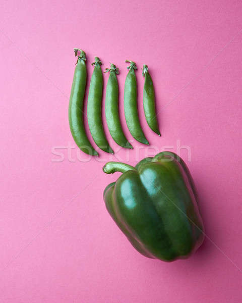 green pea pods and green sweet pepper on a pink background Stock photo © artjazz
