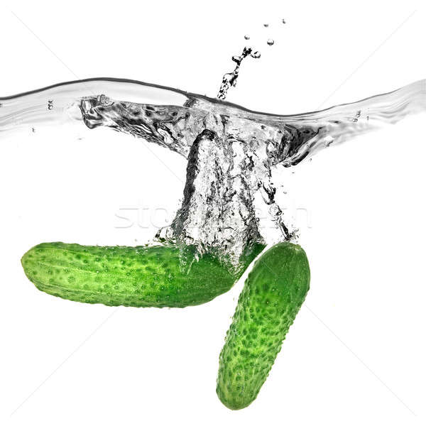 green cucumbers dropped into water isolated on white Stock photo © artjazz