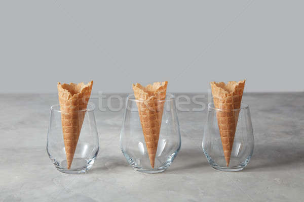 The pattern of wafer ice cream cones empty in the vases on a gra Stock photo © artjazz