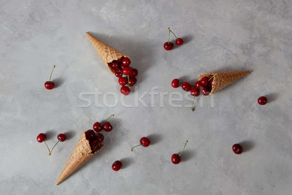 Freshly natural organic cherry pattern with wafer cones on a gra Stock photo © artjazz