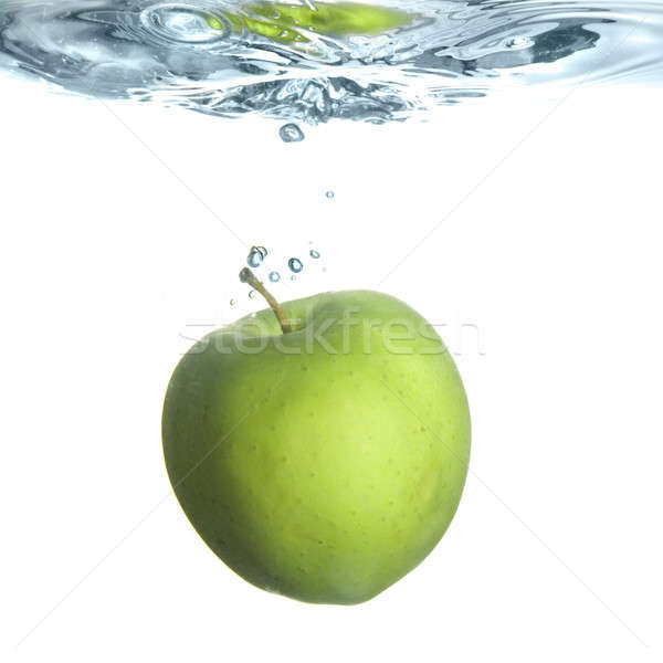 green apple dropped into water with bubbles isolated on white Stock photo © artjazz