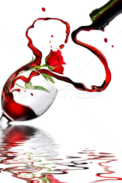 Heart from pouring red wine in goblet isolated on white Stock photo © artjazz