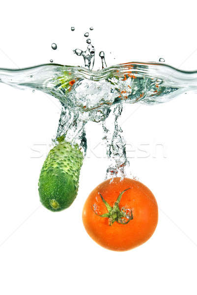 red tomato and green cucumber dropped into water isolated on white Stock photo © artjazz
