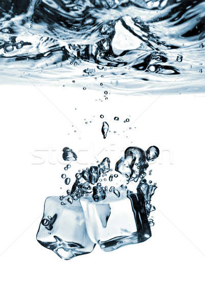 Stock photo: ice cubes dropped into water with splash isolated on white