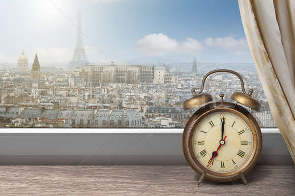 Stock photo: View of Paris and Eiffel tower from window with alarm clock