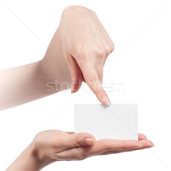 Womans hands holding and pointing empty visiting card isolated on white Stock photo © artjazz