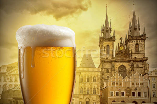 Glass of beer against Tyn Church in Prague Stock photo © artjazz