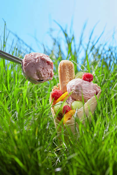 Ice cream with fruit in a waffle cone Stock photo © artjazz