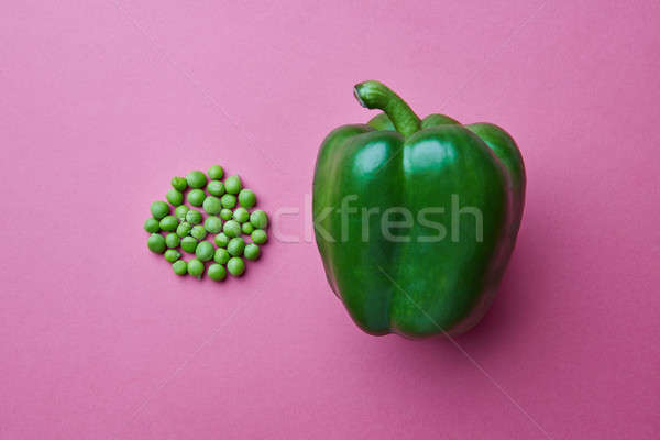 Fresh green bell pepper and green peas on a pink background Stock photo © artjazz