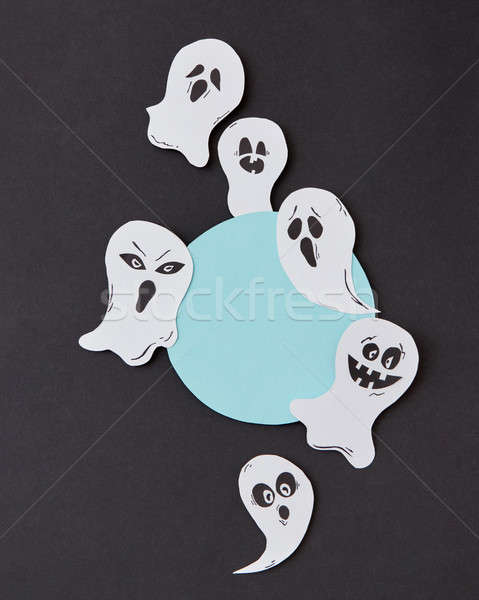 Halloween party round frame with habdcrafted laughing flying scary ghosts, spirits, around it on a b Stock photo © artjazz