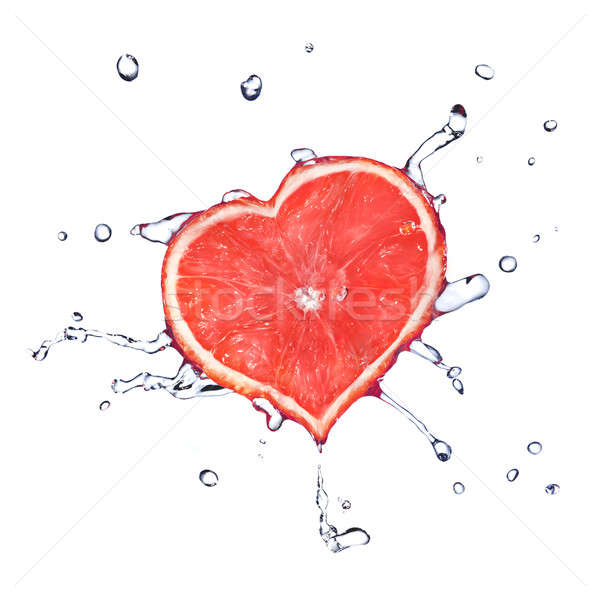 heart from grapefruit dropped into water with splash isolated on white Stock photo © artjazz