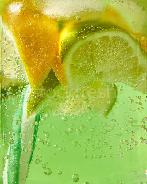Close-up of sparkling fresh lemonade with ice, slices of lime, l Stock photo © artjazz