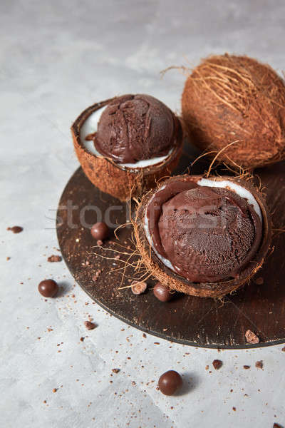 Fresh appetizing chocolate ice cream in a coconut shell with cho Stock photo © artjazz