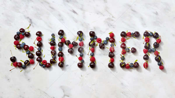 Summer background with summer berries - word 'SUMMER' from cherry, raspberry, blueberries on gray st Stock photo © artjazz