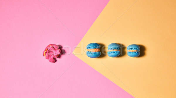 A bright composition of blue macaroons and one crushed pink maca Stock photo © artjazz