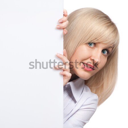 embarrassed young woman holding white empty paper isolated on white Stock photo © artjazz
