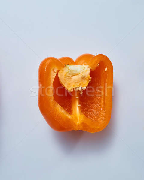half a fresh yellow pepper isolated on blue background Stock photo © artjazz
