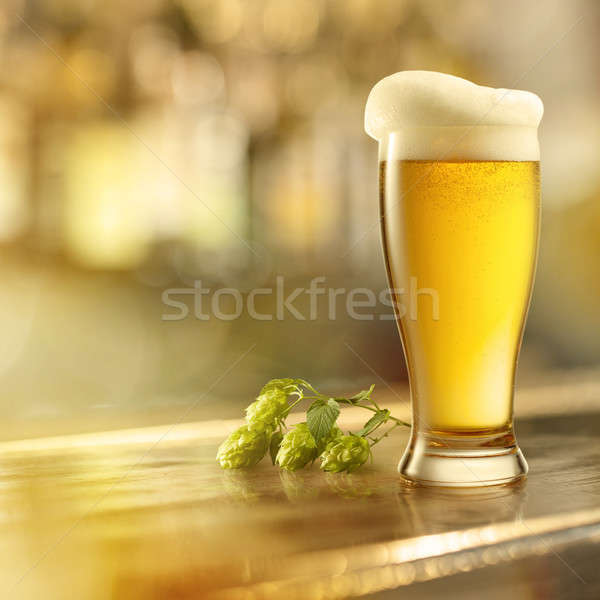 glass of beer with foam on the bar Stock photo © artjazz