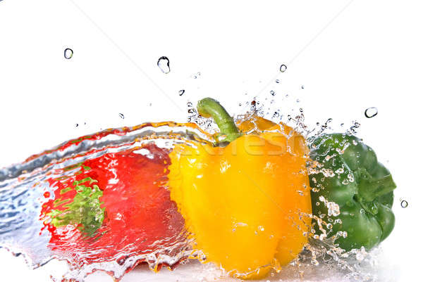 Stock photo: red, yellow and green pepper with water splash isolated on white