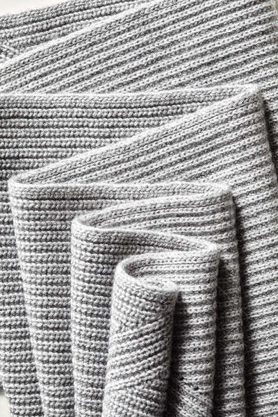 Draped melange gray woolen knitted fabric as background. Stock photo © artjazz