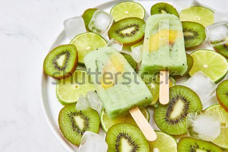 Ice lolly. Sweet melting ice cream with pieces of different frui Stock photo © artjazz