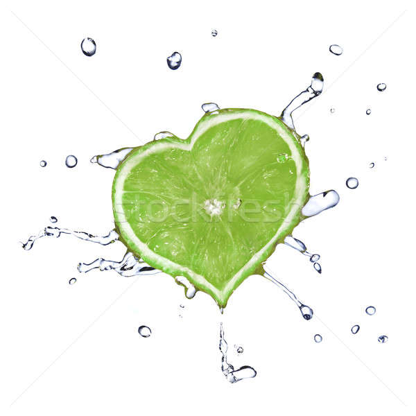 Stock photo: heart from lime dropped into water isolated on white