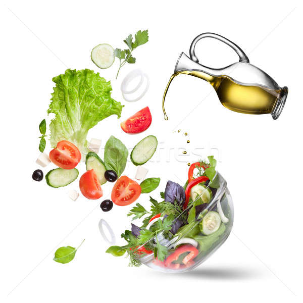 Falling vegetables for salad and oil isolated Stock photo © artjazz