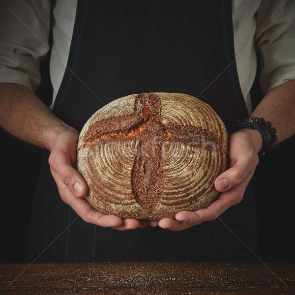Men's hands hold bread Stock photo © artjazz