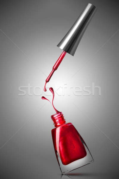 red nail polish bottle with splash Stock photo © artjazz