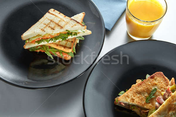 delicious breakfast sandwiches and orange juice Stock photo © artjazz