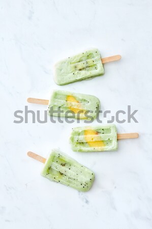 Vegan kiwi ice cream with mint and slice kiwi on marble light background, flat lay Stock photo © artjazz