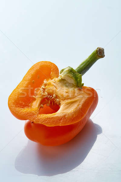 half a yellow pepper with seeds on a gray background Stock photo © artjazz
