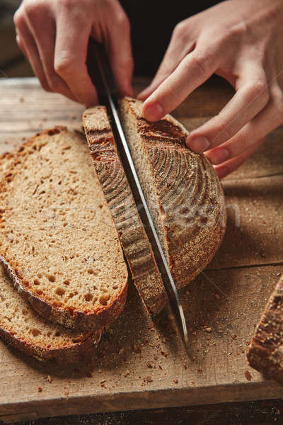 Male hands slicing homemade bread Stock photo © artjazz